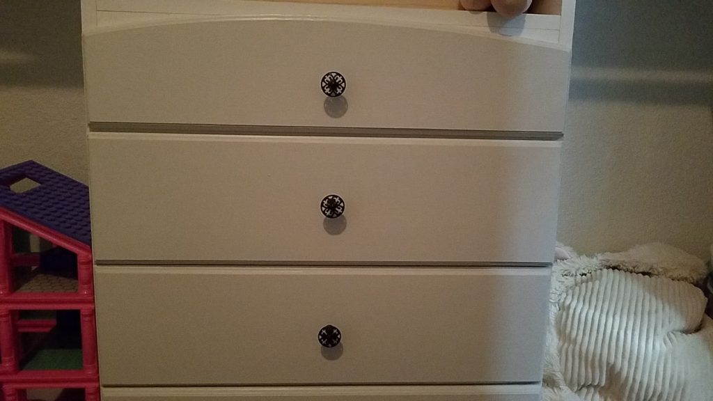 Twin Reach-In Closet Space Drawers Has Ornate Doorknobs