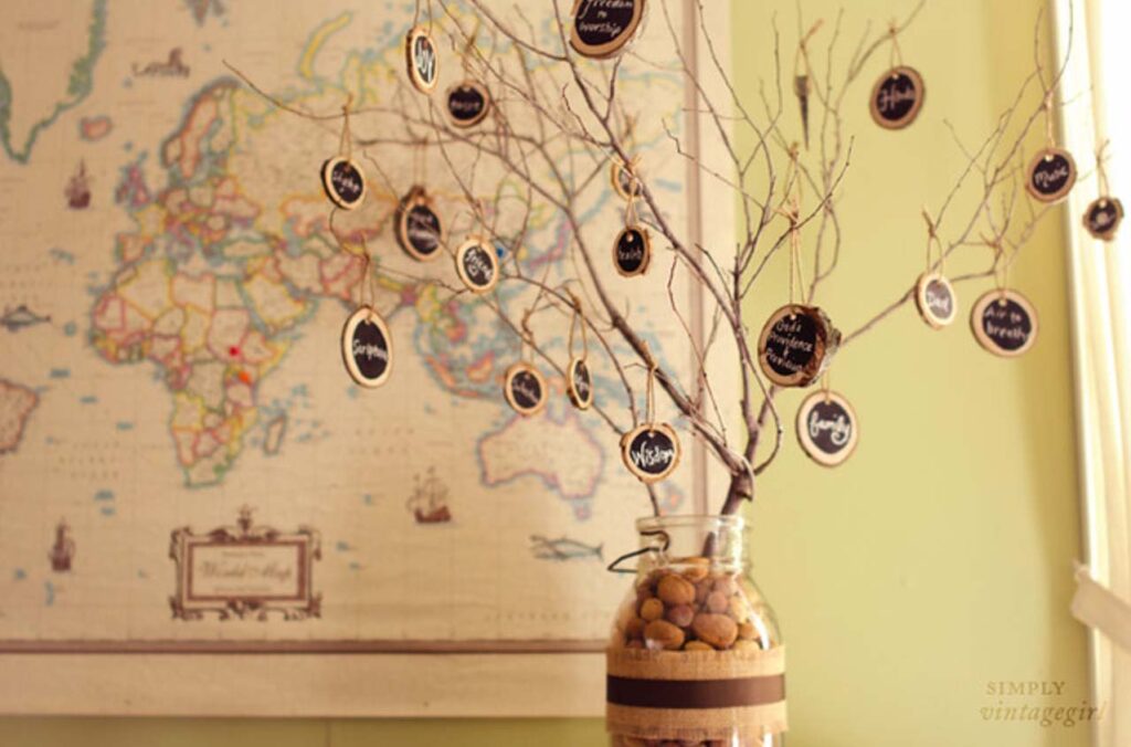 Clear Jar with stones, branches adorned with thankful tags