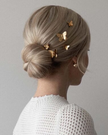 Alex Gaboury Low Bun Hairstyle with butterfly pins.