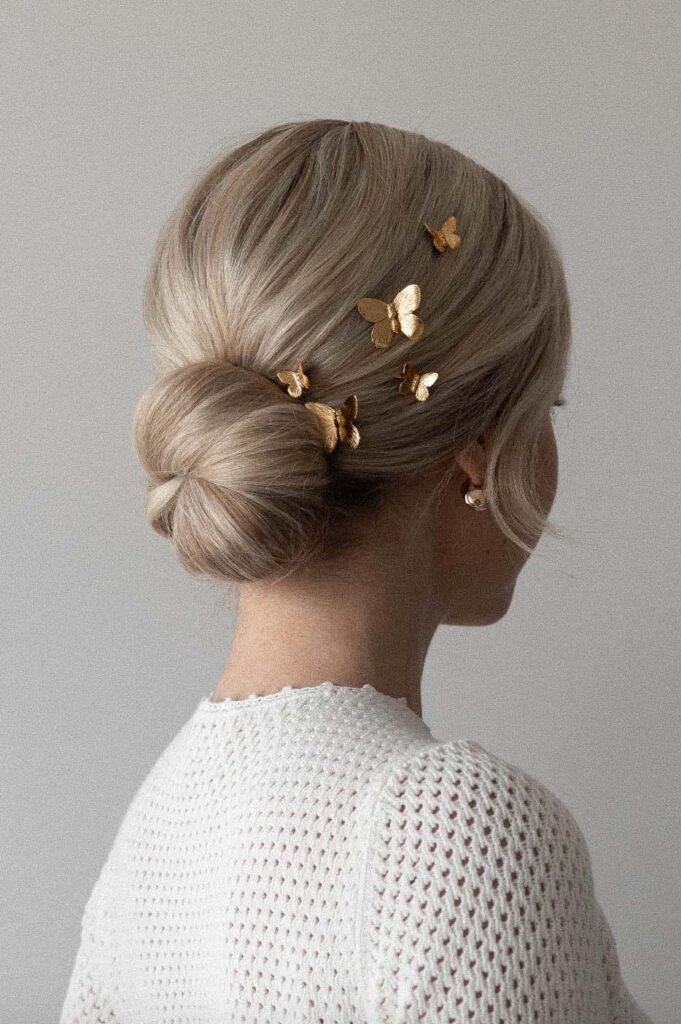 Alex Gaboury Low Bun Hairstyle with butterfly pins.