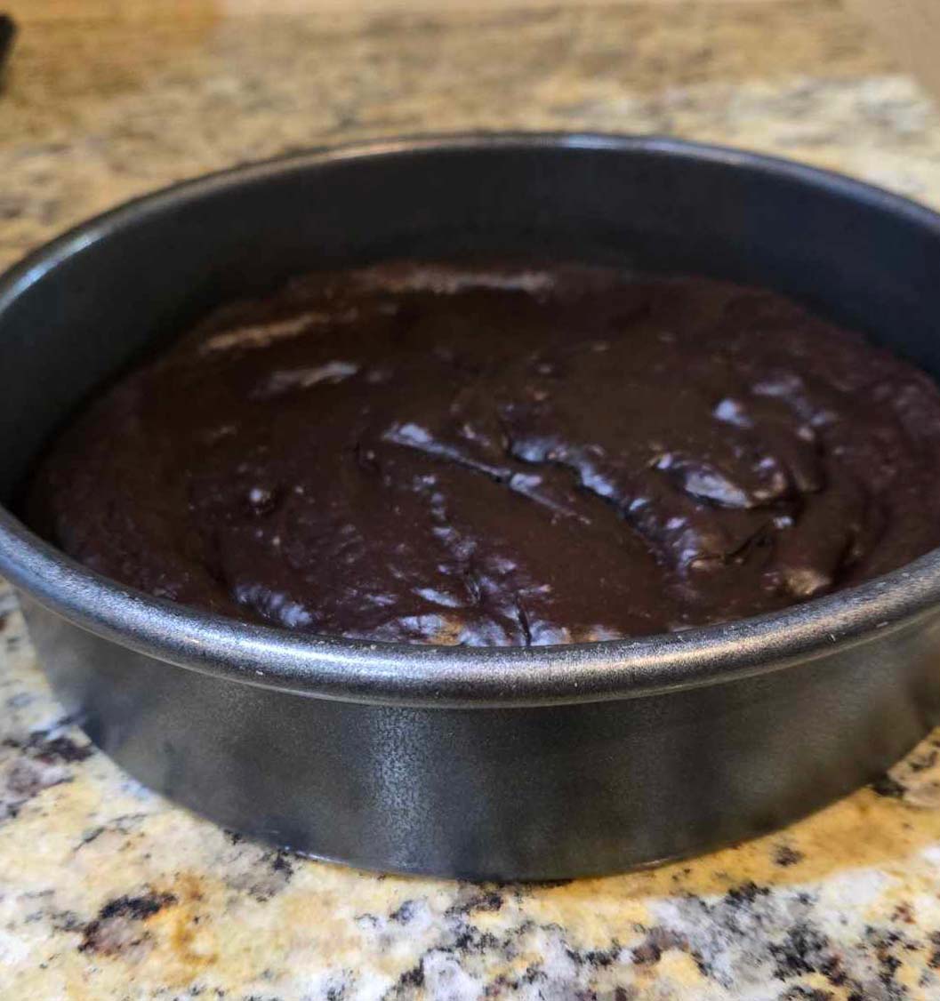 Avocado Brownies in dark metal round baking pan.