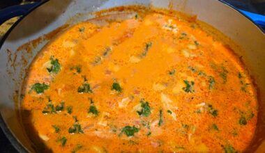 Chicken Tortellini Soup in a pot on a stove.