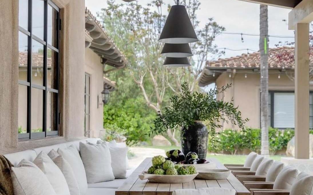 Patio with long table bench and chairs.