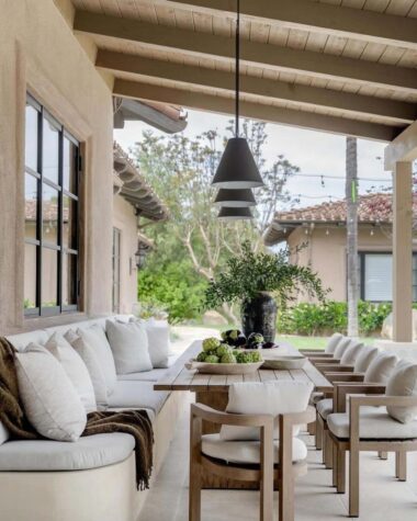 Patio with long table bench and chairs.