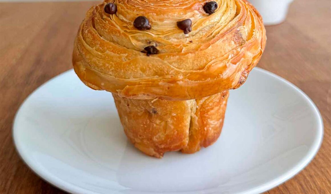 chocolate chip sourdough cruffin on a white plate