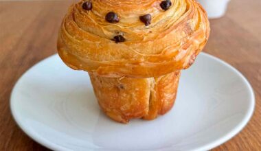 chocolate chip sourdough cruffin on a white plate