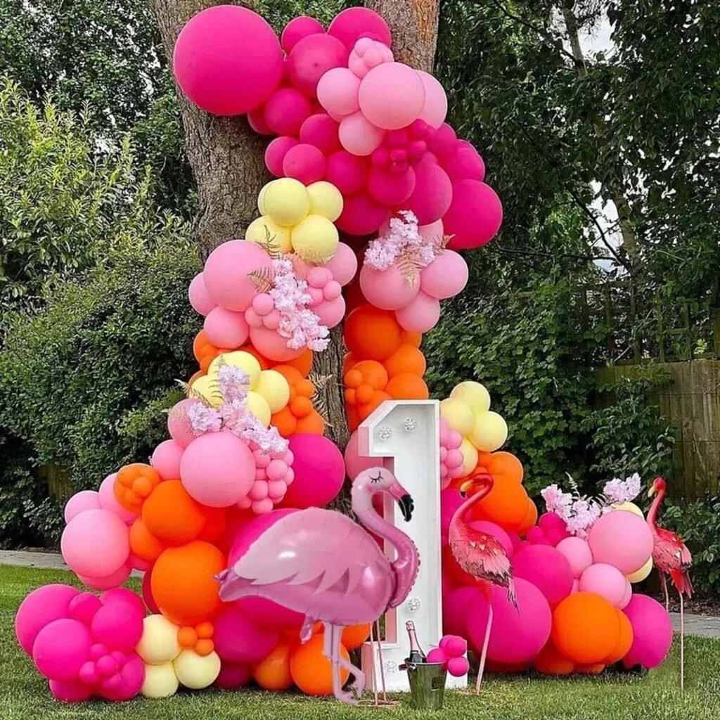 Flamingo Tropical Balloon Garland against a tree.