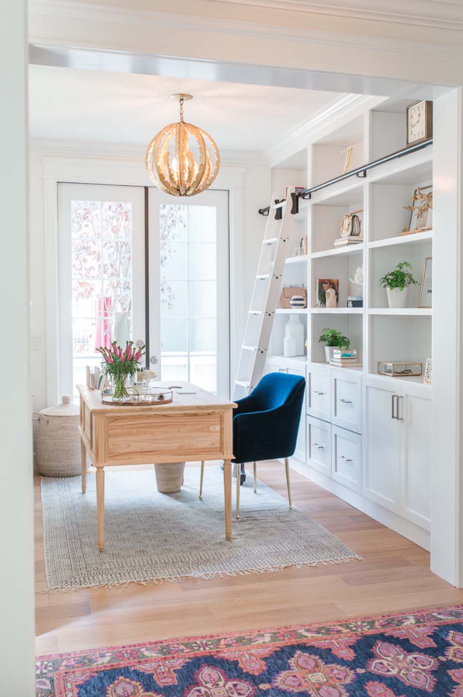 Desk and rolling ladder in home office