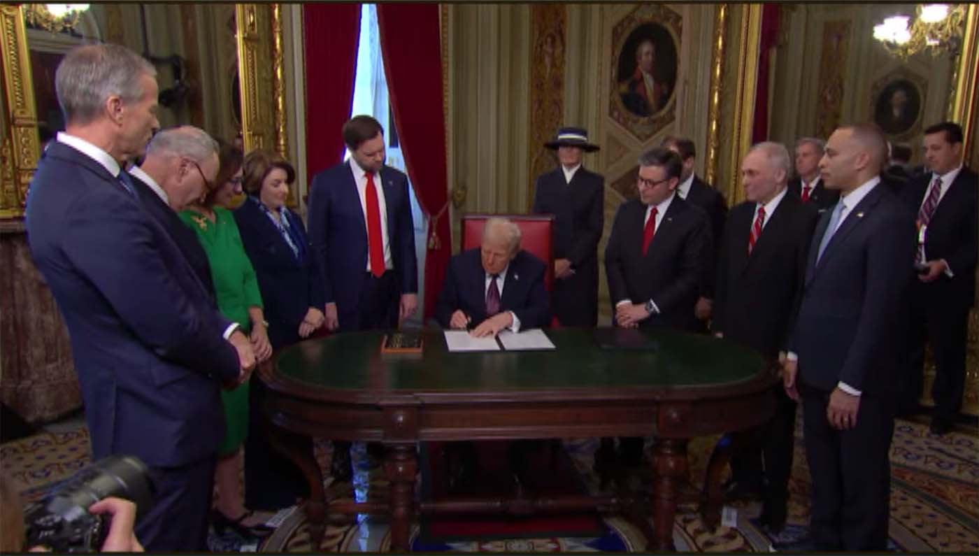 President Trump signs executive orders after inauguration ceremony.