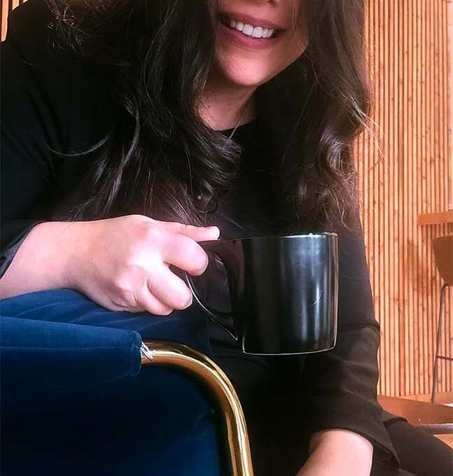 Adrienne Balkum with cup of coffee
