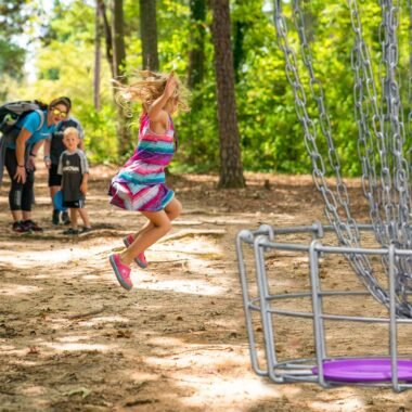 Family playing disc golf.