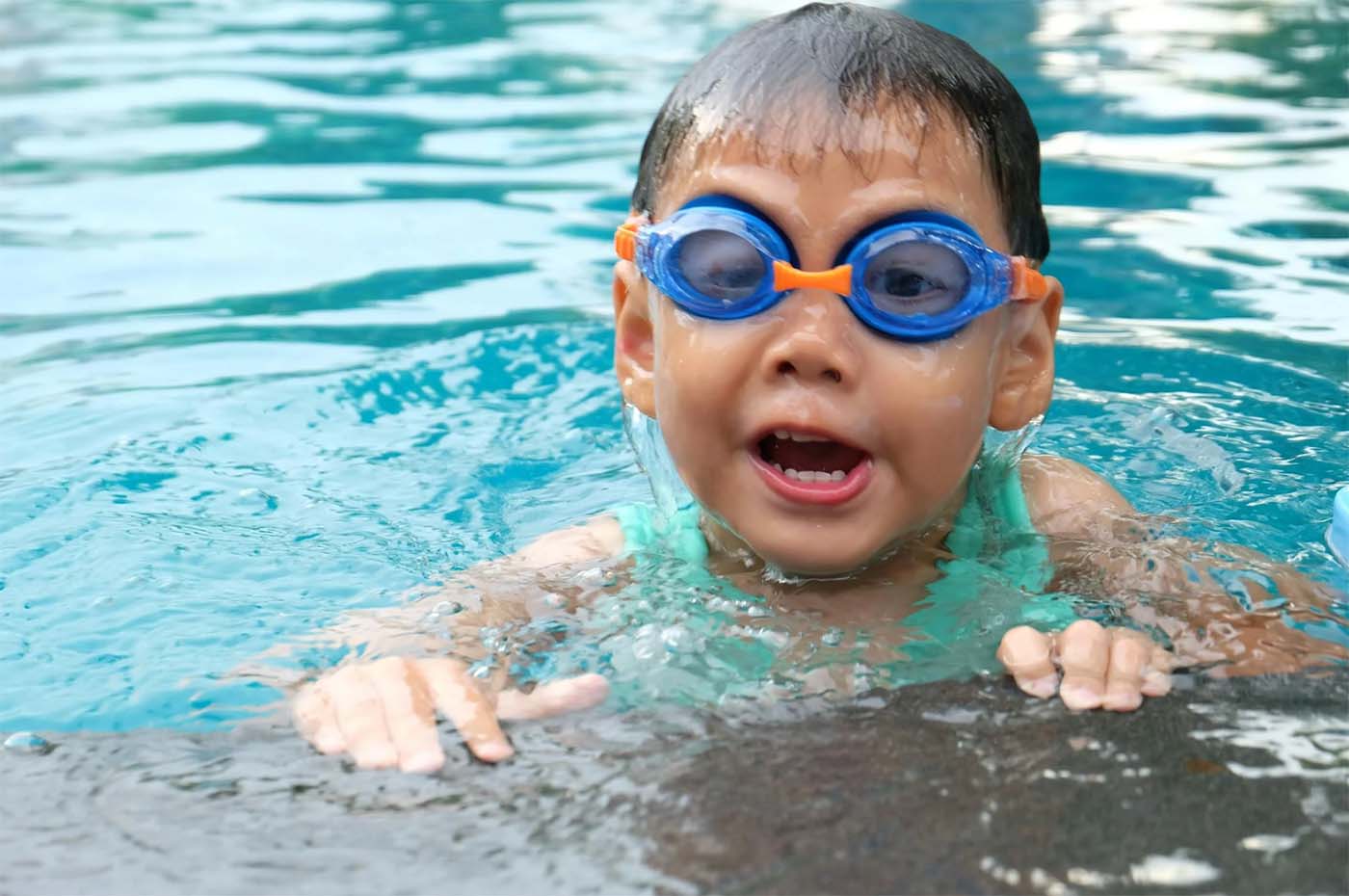 Toddler Swimming with Blue Goggles