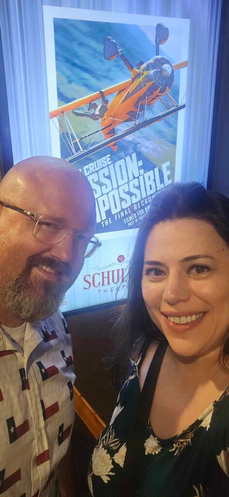 Balkum's in front of movie poster of the Mission Impossible The Final Reckoning