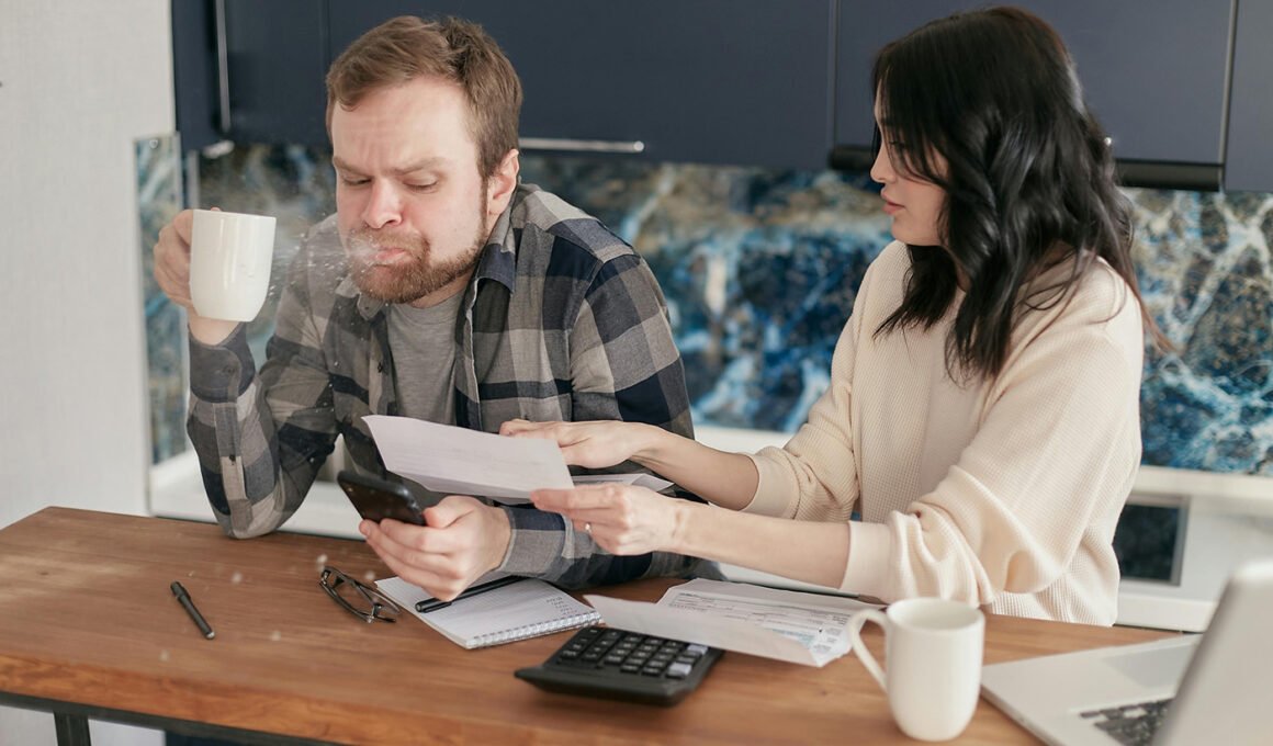 Man Spitting Out Drink Reviewing Invoice Statements
