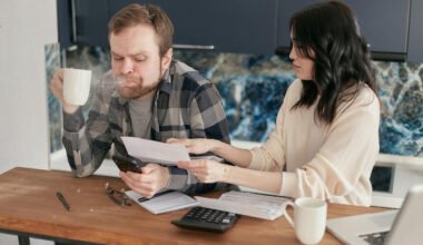 Man Spitting Out Drink Reviewing Invoice Statements