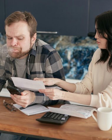 Man Spitting Out Drink Reviewing Invoice Statements