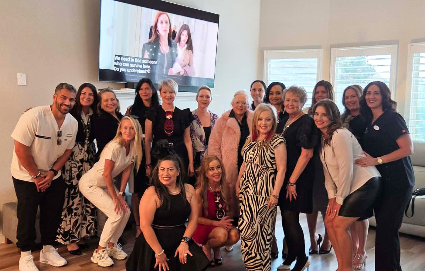 Group of women gathered at a “Devil Wears Prada” charity party supporting Women In Need in North Texas