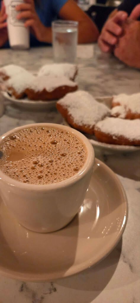 Fried beignets and coffee at Cafe du Monde | Photo courtesy of Adrienne Balkum
