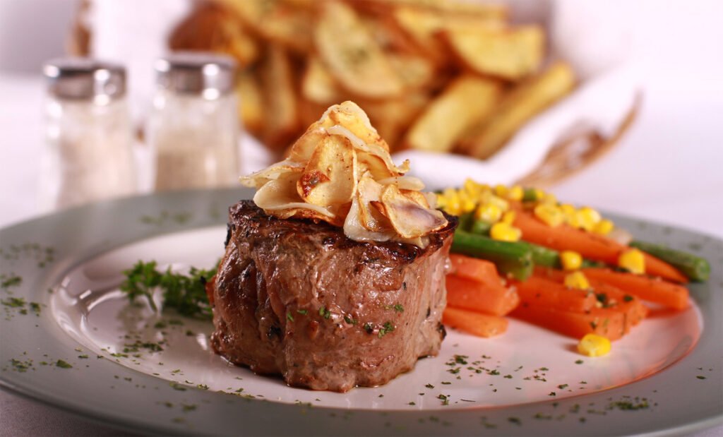 Gourmet steak, vegetables and fries.