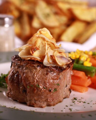 Gourmet steak, vegetables and fries.