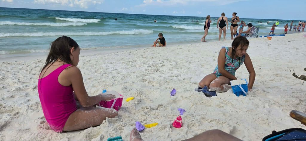Genevieve and Nicolette making sandcastles.